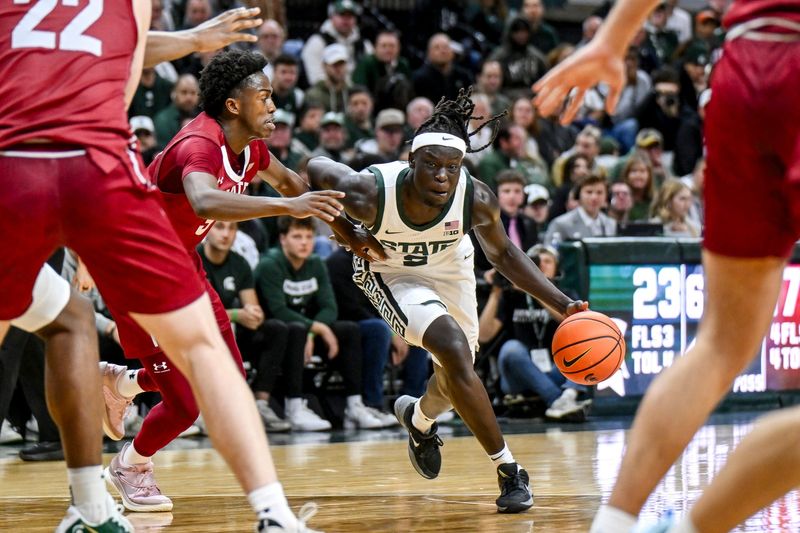 Michigan State's Kur Teng, right, moves the ball as Colgate's Jalen Cox defends during the first half on Monday, Nov. 3, 2025, at the Breslin Center in East Lansing.