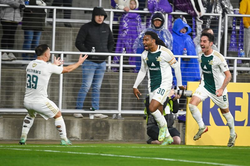 Defenseman Devon Amoo-Mensah (middle) celebrates with midfielders Jay Chapman (right) and Ryan Williams (left) in Detroit City's FC 1-0 USL playoff win over Louisville City FC on Saturday, Nov. 1.
