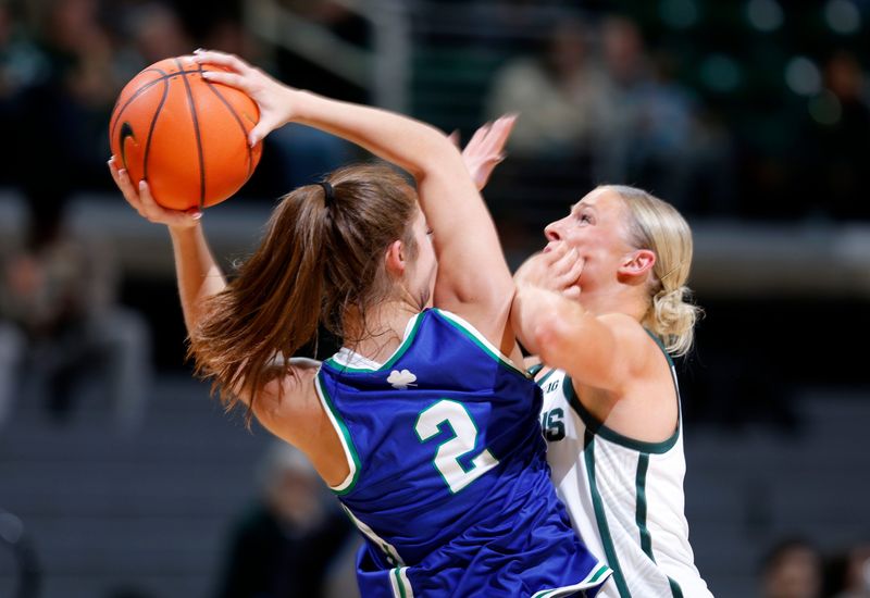 Michigan State's Theryn Hallock, right, pressures Mercyhurst's Lena Walz (2), Tuesday, Nov. 4, 2025, in East Lansing.
