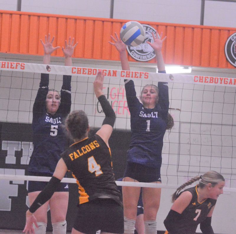 Sault Ste. Marie's Alexandra Balyeat (5) and Grace Mayer (1) attempt to block an attack from Ogemaw Heights' Brynn Provoast (4) during an MHSAA Division 2 district volleyball semifinal at Cheboygan on Wednesday, Nov. 5.