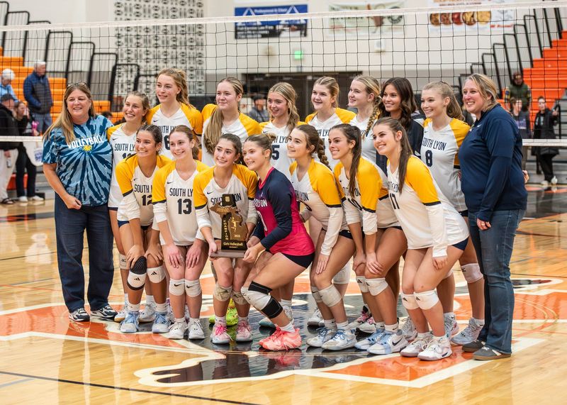 South Lyon celebrates winning the Division 1 volleyball district final on Thursday, Nov. 6, 2025, at Northville High School.