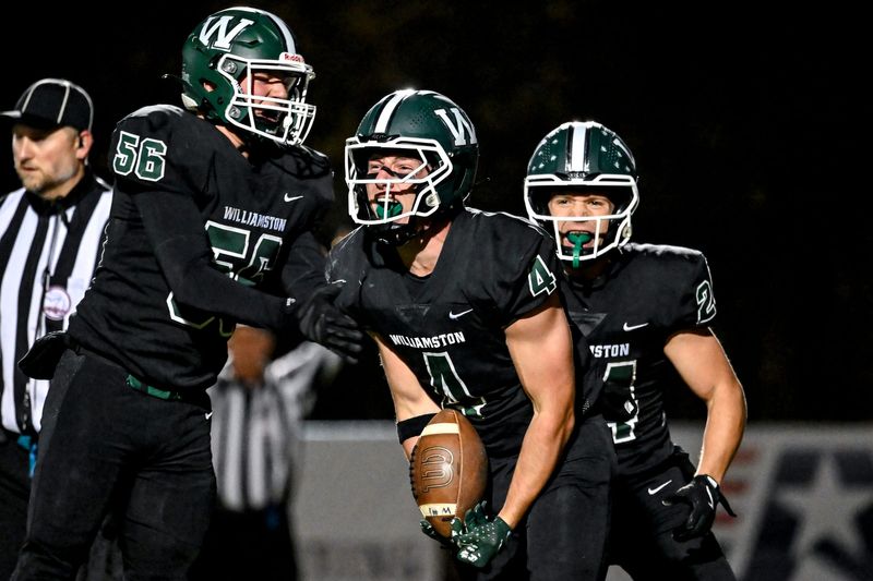 Williamston's Joseph Smith, center, celerbrates with teammates Evan Delp, left, and Eston Thorburn during the second quarter in the game against Haslett on Friday, Nov. 7, 2025, at Larkin and Nortman Memorial Field in Williamston.