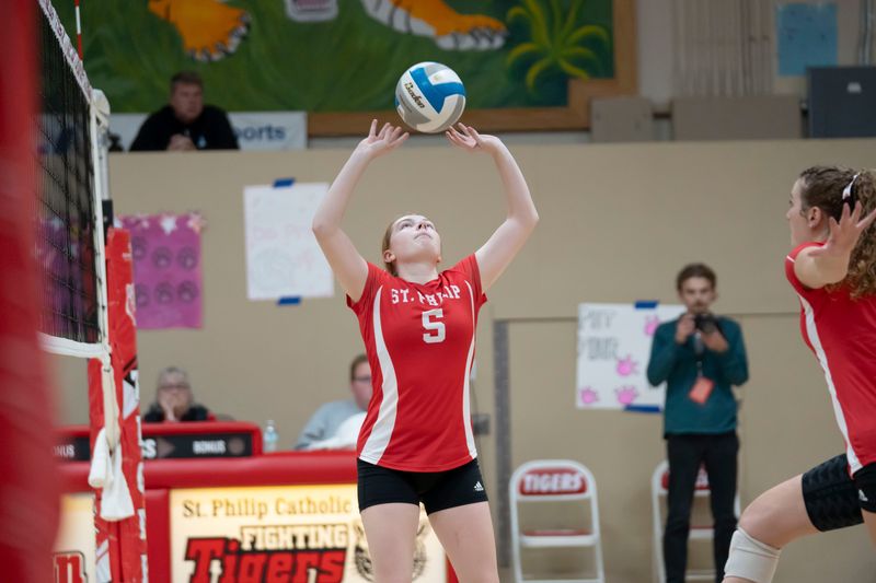 St. Philip junior Addi Dzwik sets for senior Cecelia Bellin during a district final match against Climax-Scotts at St. Philip Catholic Central High School on Friday, Nov. 7, 2025.