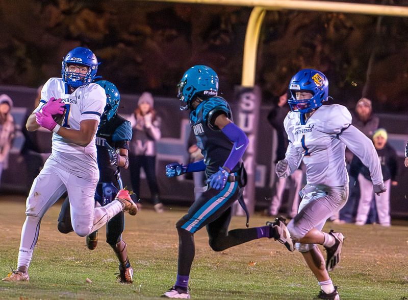 Trey Oldenburg of Jefferson carries the ball during a 33-21 Division 5 state playoff victory over Summit Academy on Friday, Nov. 7, 2025.