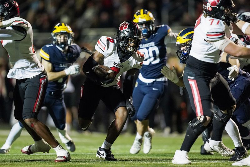 Grand Blanc junior running back Jeremiah Coleman (2) runs the ball during the first half against Clarkston at Clarkston High School in Clarkston on Friday, Nov. 7, 2025.