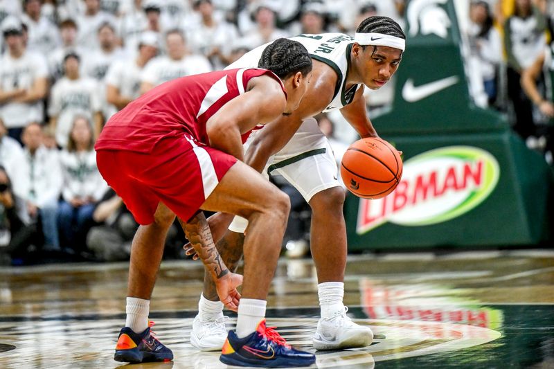 Michigan State's Jeremy Fears Jr., right, moves the ball as Arkansas' Darius Acuff Jr. defends during the first half on Saturday, Nov. 8, 2025, at the Breslin Center in East Lansing.