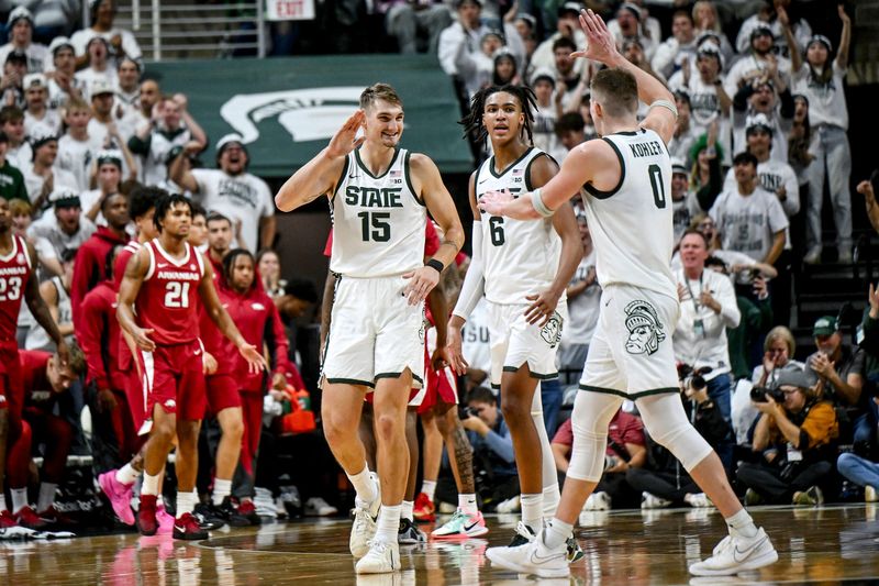 Michigan State's Carson Cooper, left, celebrates with Jaxon Kohler, right, after a score against Arkansas during the second half on Saturday, Nov. 8, 2025, at the Breslin Center in East Lansing.