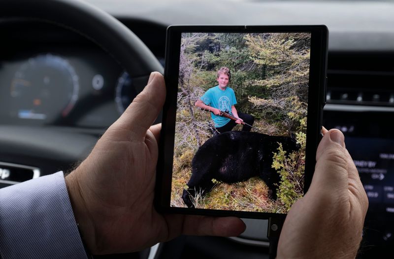 Encounters with wildlife are common in the eastern Upper Peninsula. DeTour Area Schools Superintendent Robert Vaught shows a photo of seventh-grader Evan Schumacker and the 503-pound bear he killed recently on a hunt with his grandpa.