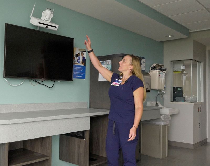 Emily Banner, a registered nurse at Henry Ford Jackson Hospital, explains how technology built into patient room TVs allows virtual nurses to conduct safety checks, help with admissions and discharges, answer patient questions and perform other tasks remotely.
