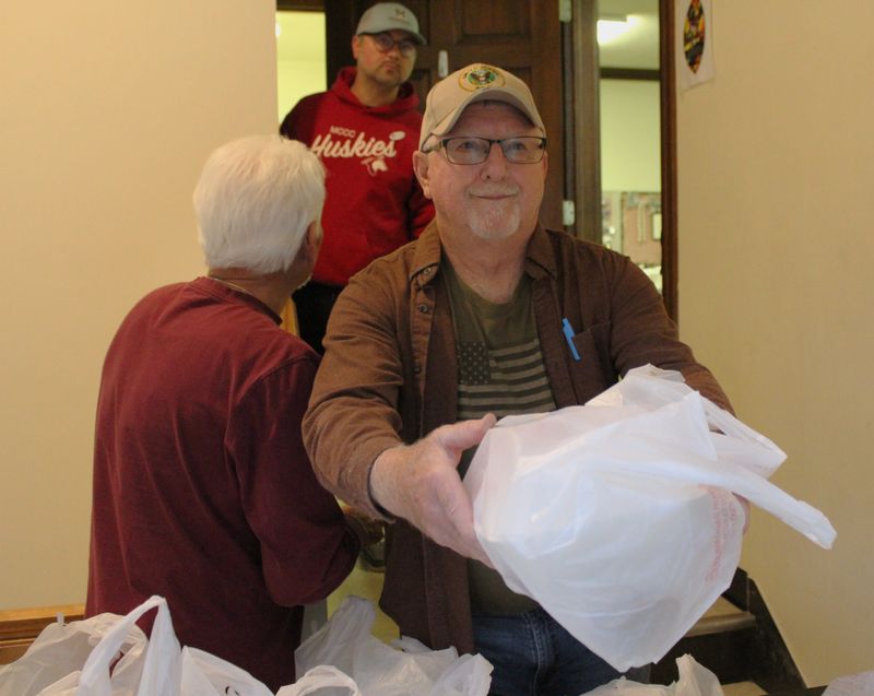 Tim Schilling, a member of Trinity Episcopal Church in Monroe, helps serve meals as part of the GodWorks! program. The soup kitchen serves free meals in host churches. Volunteers are needed to help with preparing meals and food donations.