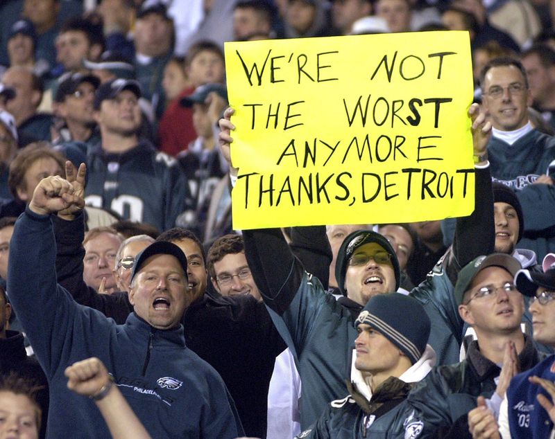 An Eagles fan holds up a sign during the game against Washington on Sunday, Nov. 21, 2004. The sign refers to the brawl at the Pacers-Pistons basketball game two nights earlier.