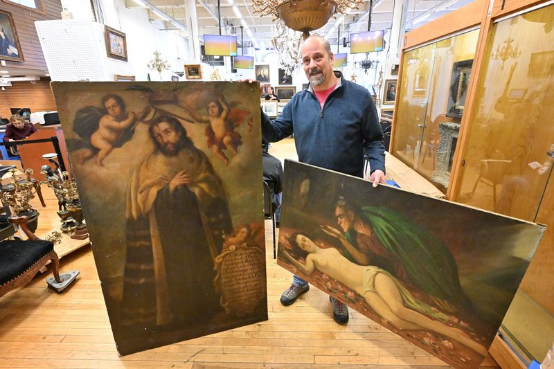 Ian Stahl brought in two large paintings to Trash or Treasure, apprising readers pieces of art, at DuMouchelles auction house in Detroit, Michigan on November 11, 2025.
