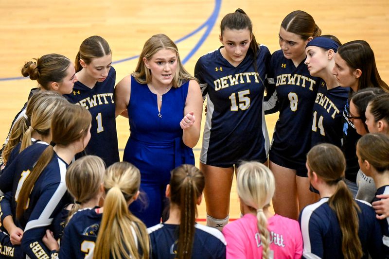 DeWitt's head coach Carley Robertson, center, talks with the team before the start of the third set against Skyline on Tuesday, Nov. 11, 2025, at Mason High School.