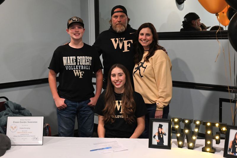 Imlay City volleyball's Emma Keeping (seated) is seen with her family after signing a national letter-of-intent to Wake Forest University at Stevo's Bar & Grill Banquet Facility on Wednesday, Nov. 12.