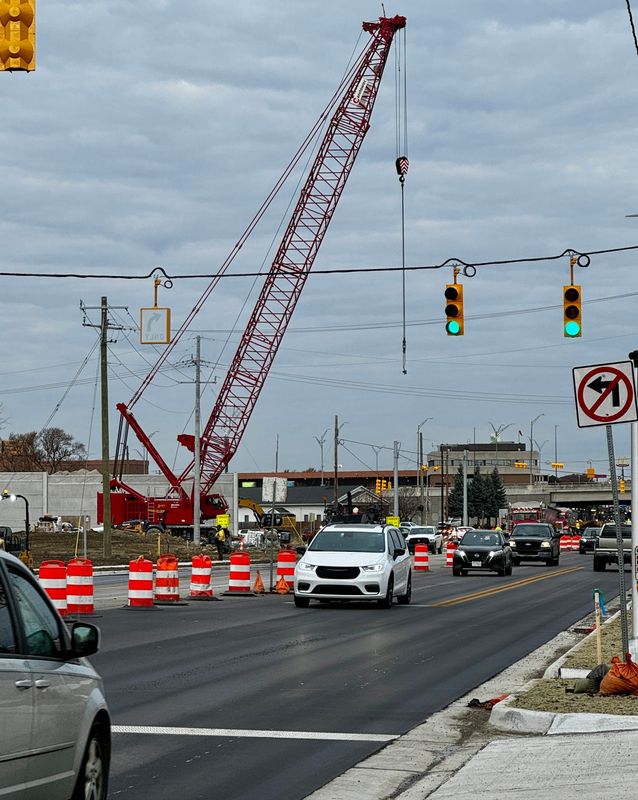 A crane operates along Pine Grove Avenue near the 10th Avenue intersection in Port Huron on Nov. 14, 2025, during the final phase of MDOT’s Blue Water Bridge plaza work.