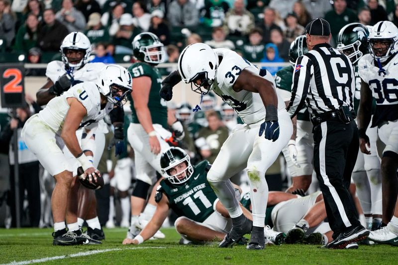 Nov 15, 2025; East Lansing, Michigan, USA; Penn State defensive end Dani Dennis-Sutton (33) celebrates a sack on Michigan State quarterback Alessio Milivojevic (11) in the fourth quarter at Spartan Stadium. Mandatory Credit: Brendan Mullin-Imagn Images