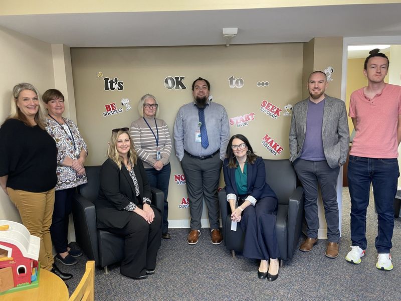 Several staff members of Monroe's Behavioral Health Urgent Care are shown in the center's family waiting room.