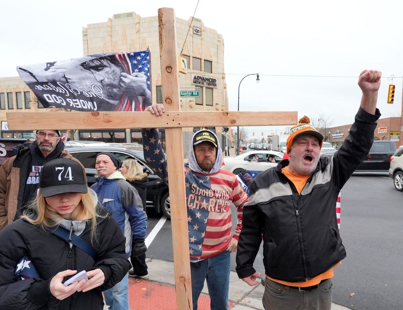 Protesters supporting anti-Muslim activist Jake Lang and his message cross the street to yell at a counterprotest of people in support of Muslims at the intersection of Michigan Avenue and Schaefer Road in Dearborn on Tuesday, Nov. 18, 2025.