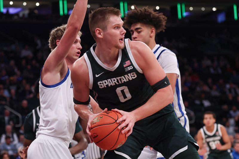 Nov 18, 2025; New York, New York, USA; Michigan State Spartans forward Jaxon Kohler (0) looks to pass during the first half against the Kentucky Wildcats at Madison Square Garden. Mandatory Credit: Vincent Carchietta-Imagn Images