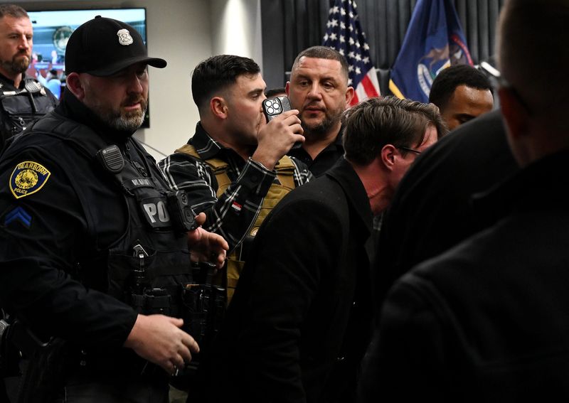 Dearborn Police officers remove Jake Lang and a couple others who were disrupting the Dearborn City Council meeting at the Dearborn Administration Center.
