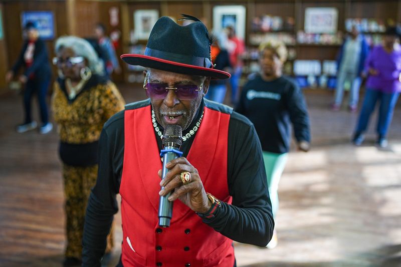 Frederick “Fast Freddy” Anderson, who became famous dancing on the Detroit TV show “The Scene,” teaches his Get Down While Sitting Down class that also features hustle in the second hour during the Sizzling Seniors program at the Lavonne M. Sheffield Bridge Center Library in Detroit, Monday, Nov. 17, 2025. Fast Freddy became a Detroit fashion icon and was featured in GQ magazine as the “Head to Toe Man” in 2000.