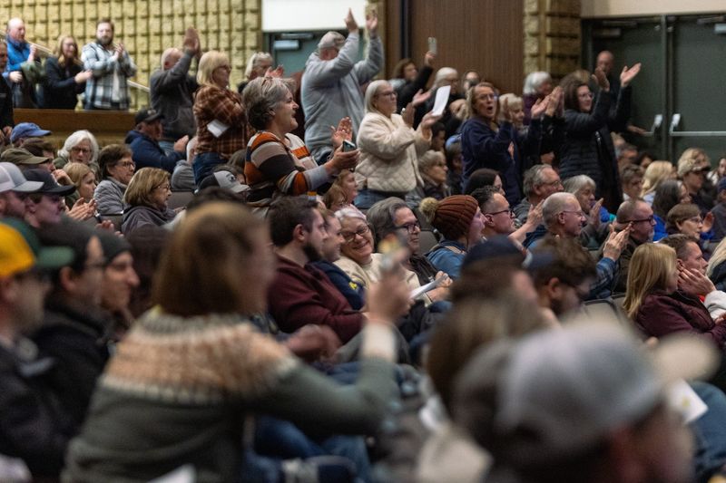 Community members give a standing ovation to the first public speaker during a meeting of the Howell Township Board of Trustees on data centers Nov. 20.