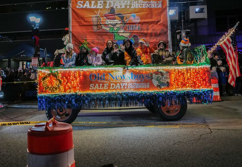 The Old Newsboys participate in the Lansing Silver Bells Electric Light Parade Friday, Nov. 21, 2025.