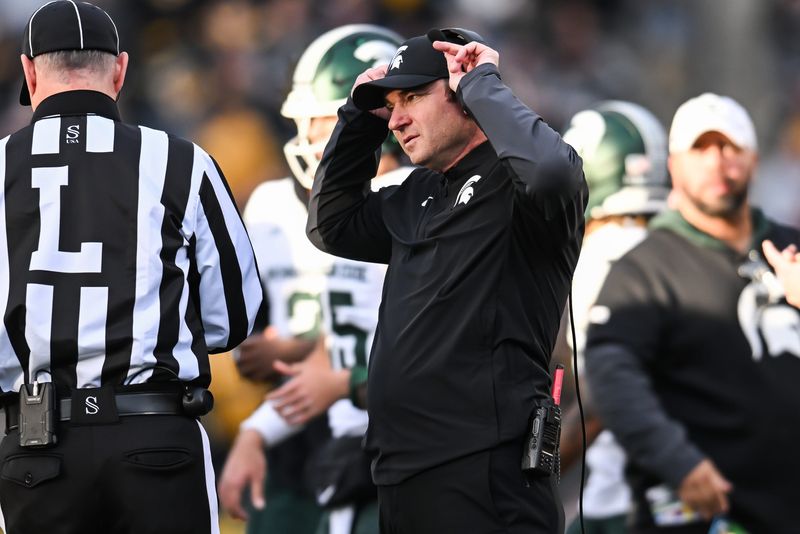 Michigan State Spartans head coach Jonathan Smith talks with an official during the second quarter against the Michigan State Spartans at Kinnick Stadium in Iowa City, Iowa, on Saturday, Nov. 22.