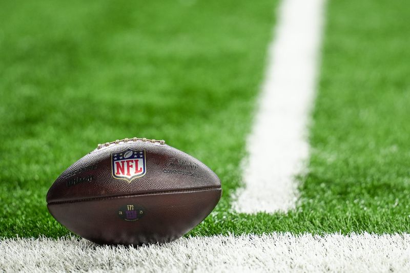 An NFL football lies on the turf as the Detroit Lions take on the New York Giants at Ford Field in Detroit on Sunday, Nov. 23, 2025.