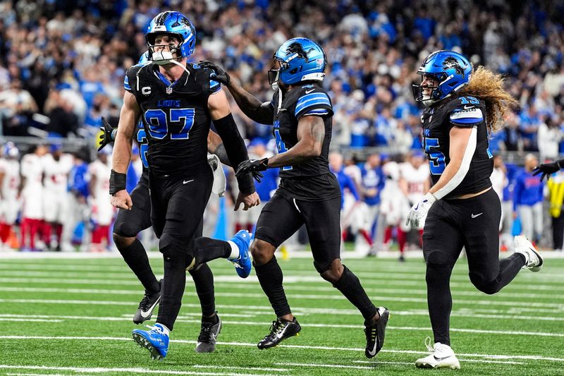 Detroit Lions defensive end Aidan Hutchinson (97) celebrates 34-27 win over New York Giants in overtime at Ford Field in Detroit on Sunday, Nov. 23, 2025.