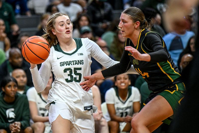 Michigan State's Kennedy Blair, left, passes the ball as Wayne State's Ally Shagena defends during the third quarter on Monday, Oct. 28, 2024, in East Lansing.