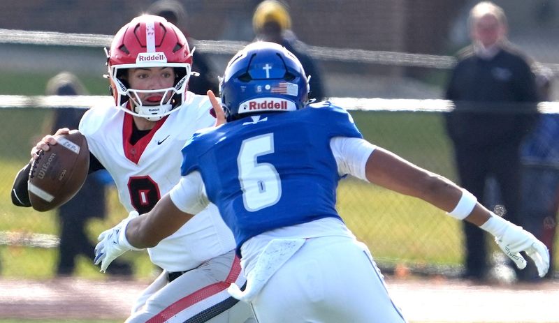 East Kentwood quarterback (8) Kayd Coffman gets pressured by the defense of Novi Detroit Catholic Central (6) Joshua Atiemo during the first half of the MHSAA Division 1 football semifinals between Novi Detroit Catholic Central and East Kentwood at Jackson High School in Jackson on Saturday, Nov. 22, 2025.