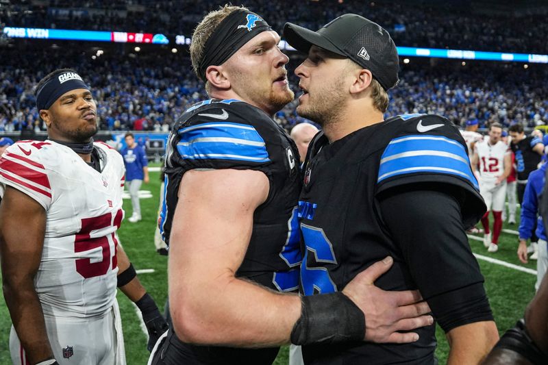 Detroit Lions defensive end Aidan Hutchinson (97) hugs quarterback Jared Goff (16) after 34-27 win over New York Giants at Ford Field in Detroit on Sunday, Nov. 23, 2025.