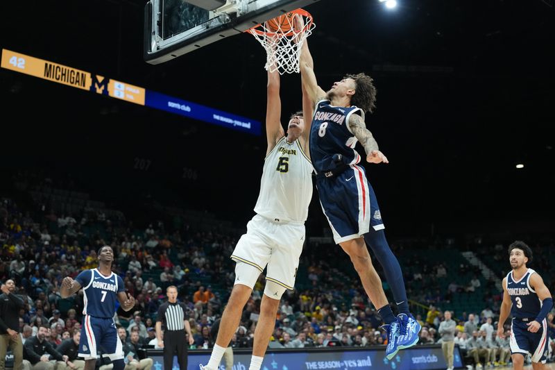 Michigan Wolverines center Aday Mara (15) dunks while defended by Gonzaga Bulldogs guard Jalen Warley (8) in the first half in the 2025 Players Era Festival championship game at MGM Grand Garden Arena in Las Vegas on Wednesday, Nov. 26, 2025.