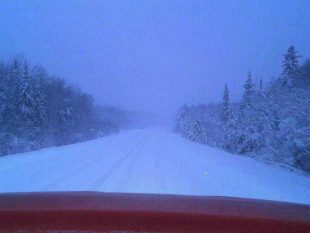 An image of a snowy road in the Upper Peninsula from a Michigan Department of Transportation snowplow and posted on the MiDrive map.
