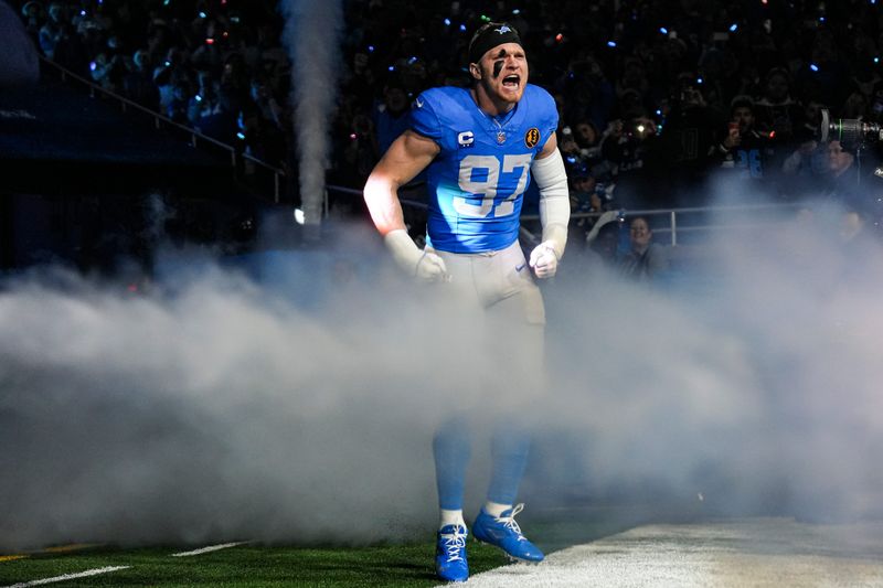 Detroit Lions defensive end Aidan Hutchinson (97) runs onto the field for players introduction before the Thanksgiving game against Green Bay Packers at Ford Field in Detroit on Thursday, Nov. 27, 2025.