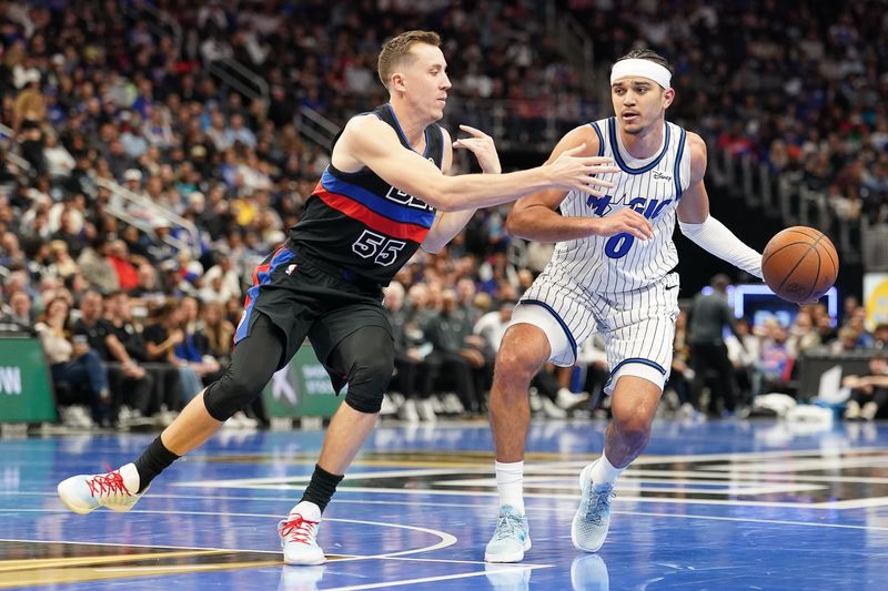Orlando Magic guard Anthony Black (0) dribbles against Detroit Pistons forward Duncan Robinson (55) at Little Caesars Arena in Detroit on Friday, Nov. 28, 2025.