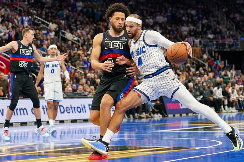 Orlando Magic guard Jalen Suggs (4) dribbles after Detroit Pistons guard Cade Cunningham (2) at Little Caesars Arena in Detroit on Friday, Nov. 28, 2025.