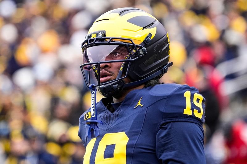 Michigan quarterback Bryce Underwood (19) looks on during warmup at Michigan Stadium in Ann Arbor on Saturday, Nov. 29, 2025.