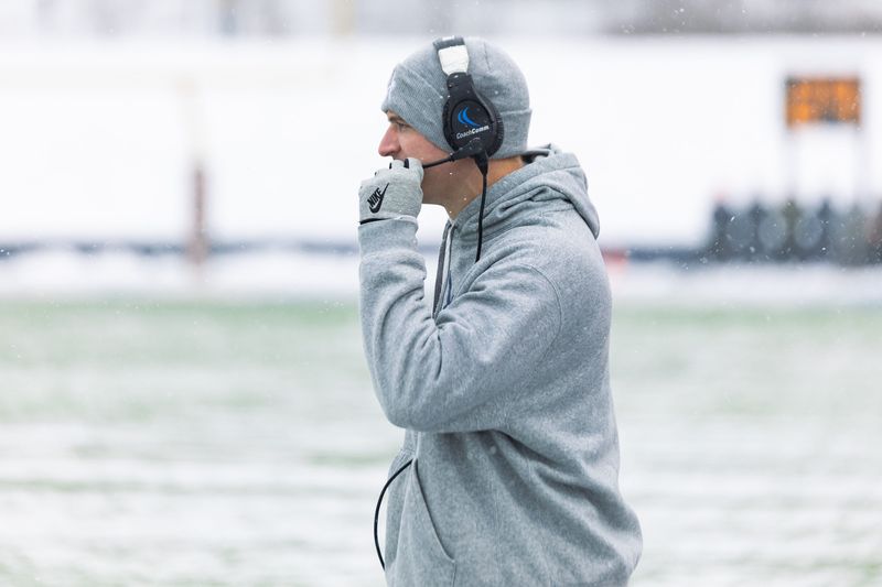 Coach Jacob Pardonnet adjusts his headset during the Hope vs Wisconsin-La Crosse football game on Saturday, Nov. 29.
