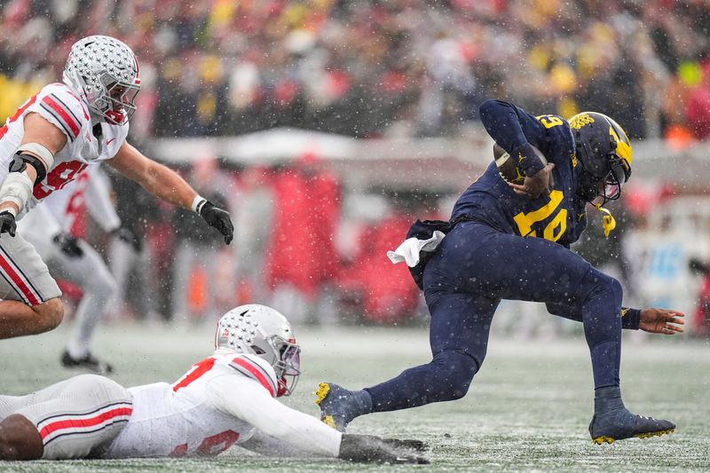 Michigan quarterback Bryce Underwood (19) is sacked by Ohio State defensive end Kenyatta Jackson Jr. (97) during the second half at Michigan Stadium in Ann Arbor on Saturday, Nov. 29, 2025.