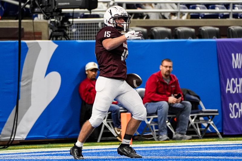 Menominee running back lineman Clayton Miller (15) celebrates scoring a touchdown against Schoolcraft during the second half of MHSAA Division 7 final at Ford Field in Detroit on Sunday, Nov. 30, 2025.