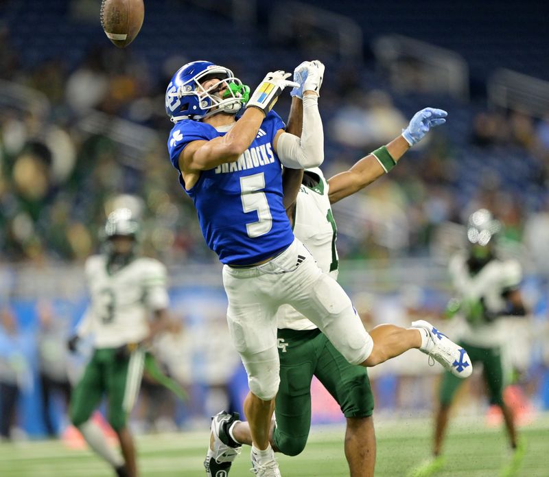 Cass TechÕs Corey Sadler Jr. (1) breaks up a pass intended for Catholic CentralÕs Samson Gash (5) in the first half. Detroit Catholic Central takes on Cass Tech in Division 1 MHSAA football finals at Ford Field in Detroit on Nov. 30, 2025.