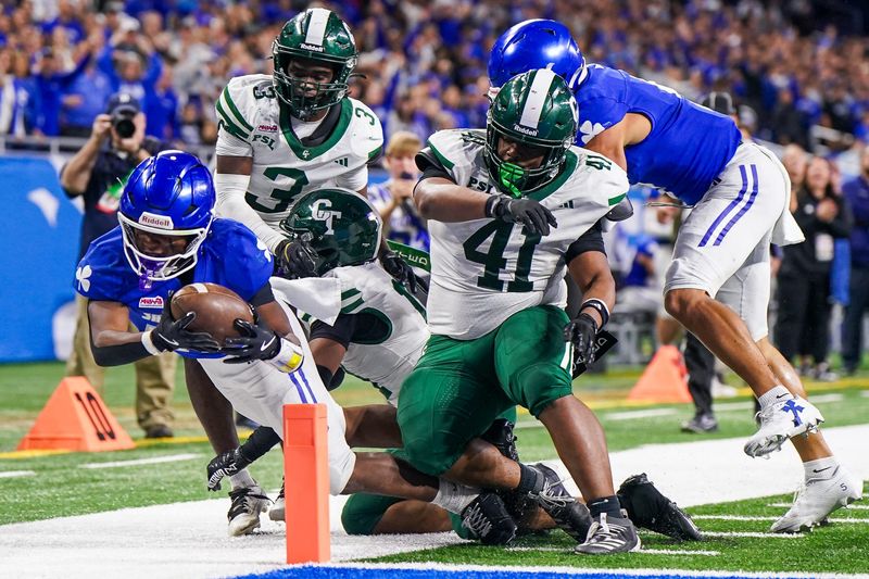 Detroit Catholic Central junior linebacker Jalen Montlouis (24) dives in a touchdown attempt against Detroit Cass Tech in the Division 1 State Championship at Ford Field on Sunday, Nov. 30, 2025.