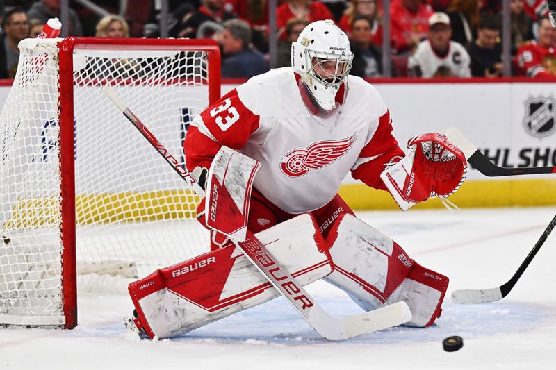 Detroit Red Wings goaltender Sebastian Cossa (33) defends the net against the Chicago Blackhawks at United Center in Chicago on Oct. 1, 2022.
