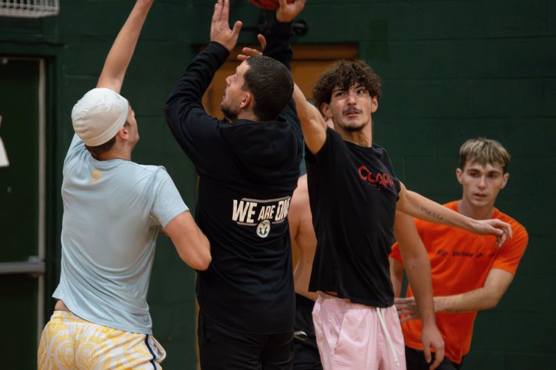 Coach Nick Wagle (center) fills in during team scrimmage time in preseason practice.