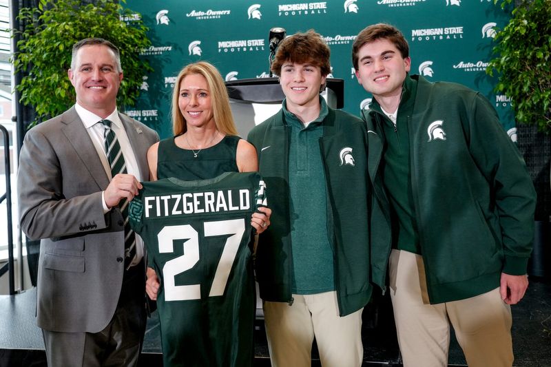 Michigan State's new football coach Pat Fitzgerald, left, his wife Stacy and two of their three sons, Brendan and Ryan, pose for a photo after an introductory press conference on Tuesday, Dec. 2, 2025, at the Tom Izzo Football Building in East Lansing.
