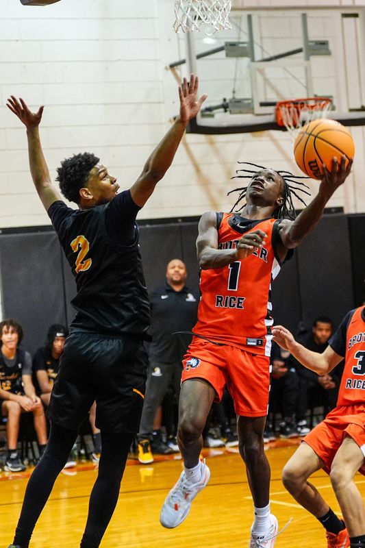 Brother Rice guard Jordan McDaniel (1) crosses over Ferndale guard Julian Cardenas (2) to score two during the first half of the high school basketball game at Brother Rice High School in Bloomfield Hills, Mich., Tuesday, Dec. 2, 2025.