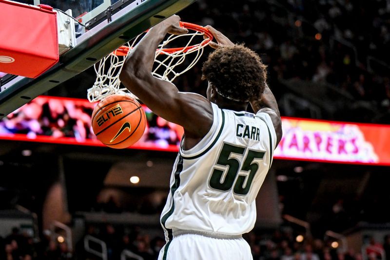 Michigan State's Coen Carr dunks against Iowa during the first half on Tuesday, Dec. 2, 2025, at the Breslin Center in East Lansing.