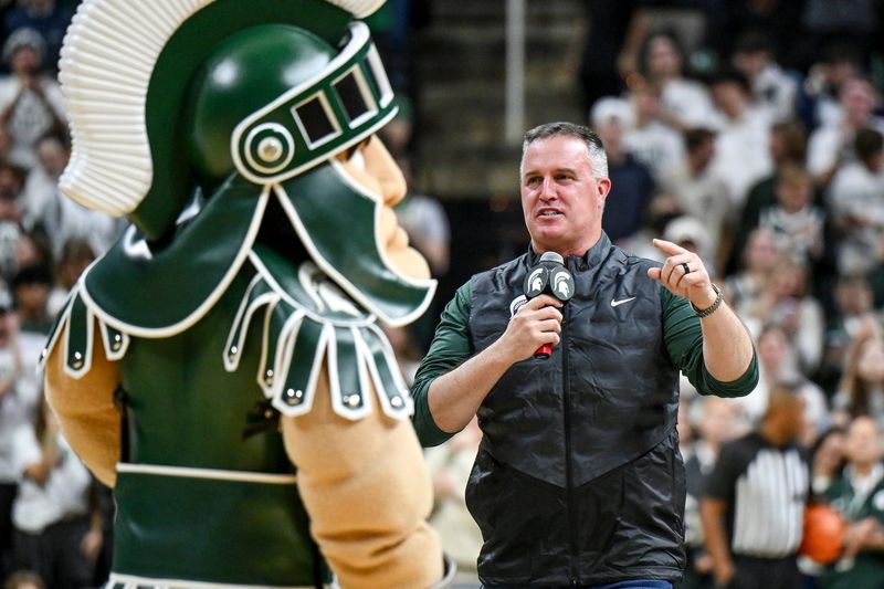 Michigan State's new football coach Pat Fitzgerald addresses the crowd during a timeout in the first half of the Spartans basketball game against Iowa on Tuesday, Dec. 2, 2025, at the Breslin Center in East Lansing.